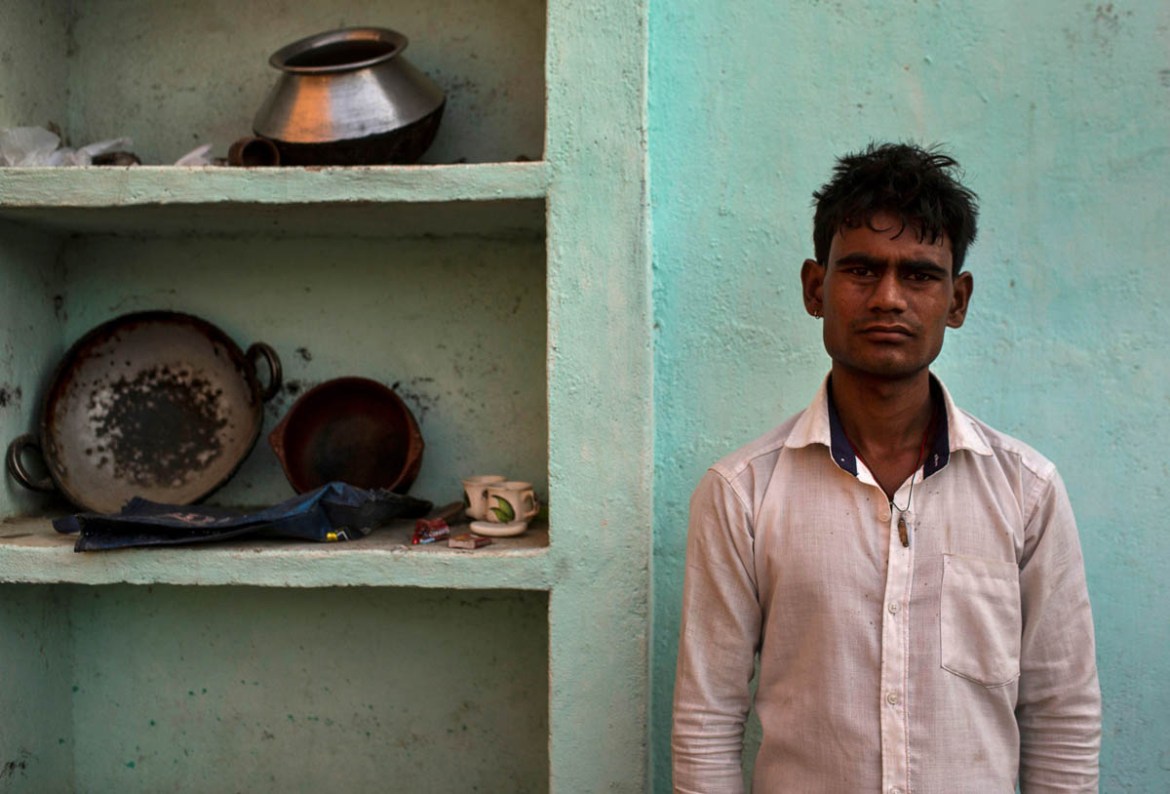 Pramod Kushwaha, a migrant worker who returned home from New Delhi with Dayaram Kushwaha, poses for a portrait during nationwide lockdown in India to slow the spread of the coronavirus, in Churari vil