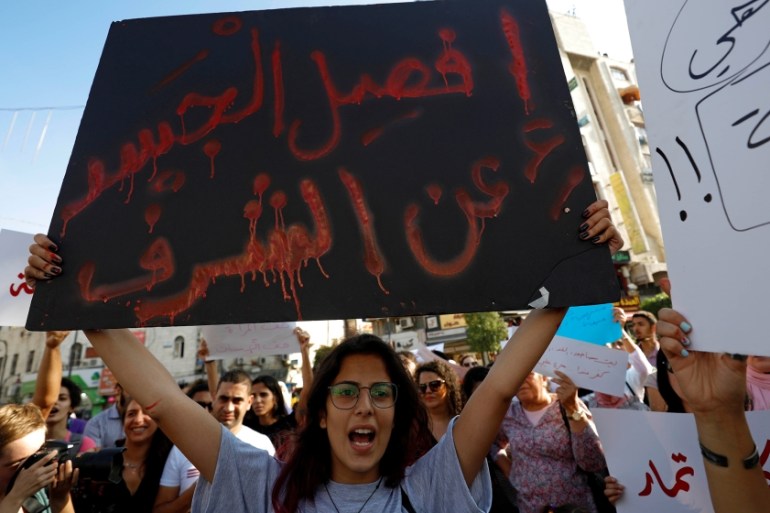 A demonstrator holds a banner during a protest demanding legal protection for women, in Ramallah in the Israeli-occupied West Bank September 4, 2019. REUTERS/Mohamad Torokman