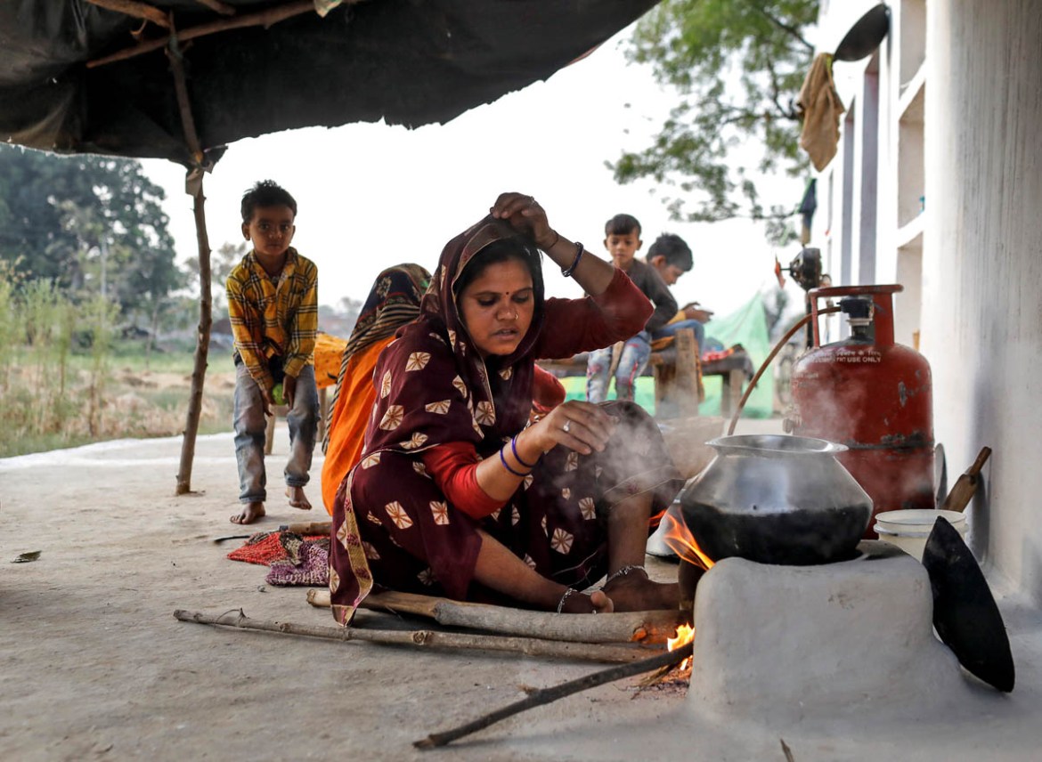 Gyanvati, a migrant worker, cooks food for her family after she returned home from New Delhi during nationwide lockdown in India to slow the spread of the coronavirus, in Jugyai village in the central