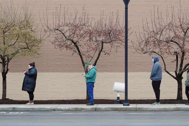 People line up at a safe social distance outside the grocery store amid the coronavirus disease (COVID-19) outbreak in Medford, Massachusetts, U.S., April 4, 2020. REUTERS/Brian Snyder TPX IMAGES OF T