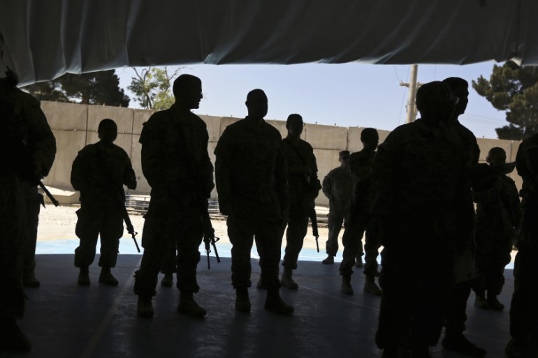 U.S. soldiers attend a naturalization ceremony while celebrating Fourth of July at Bagram airbase, north of Kabul
