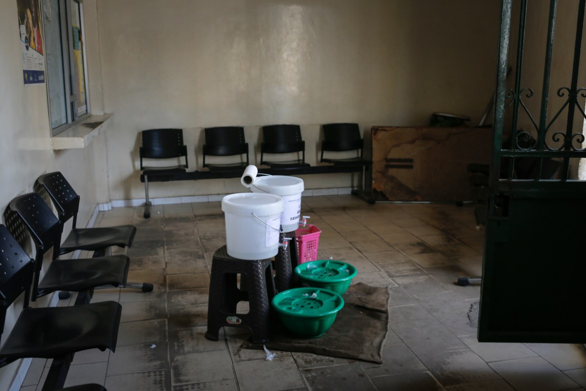 Portable hand-washing basins filled with soapy water are installed at the entrance of a hospital in Dakar. Community public health measures to fight coronavirus have become widespread in Dakar’s publi