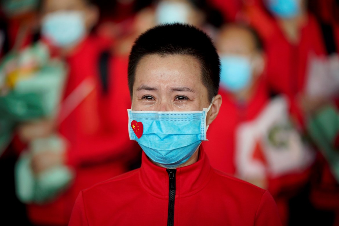 A member of a medical team weeps at the Wuhan Tianhe International Airport after travel restrictions to leave Wuhan, the capital of Hubei province and China''s epicentre of the novel coronavirus diseas