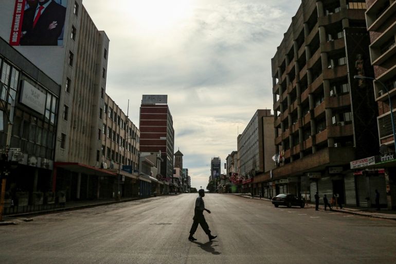 A policeman crosses an empty street during a 21-day nationwide lockdown aimed for limiting the spread of the coronavirus disease (COVID-19) in Harare, Zimbabwe, April 12, 2020. REUTERS/Philimon Bulawa