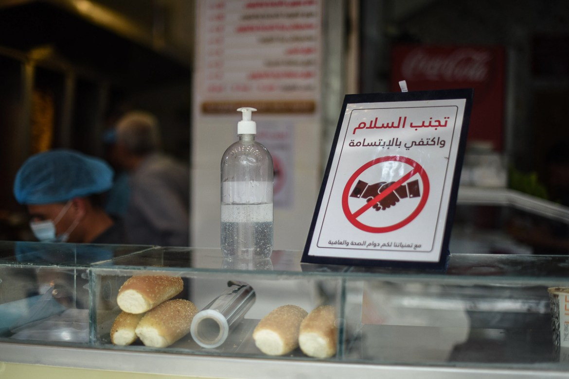 The owner of this restaurant in Khan Yunis put out a sign to discourage people from handshakes, as well as a bottle of hand sanitizer.