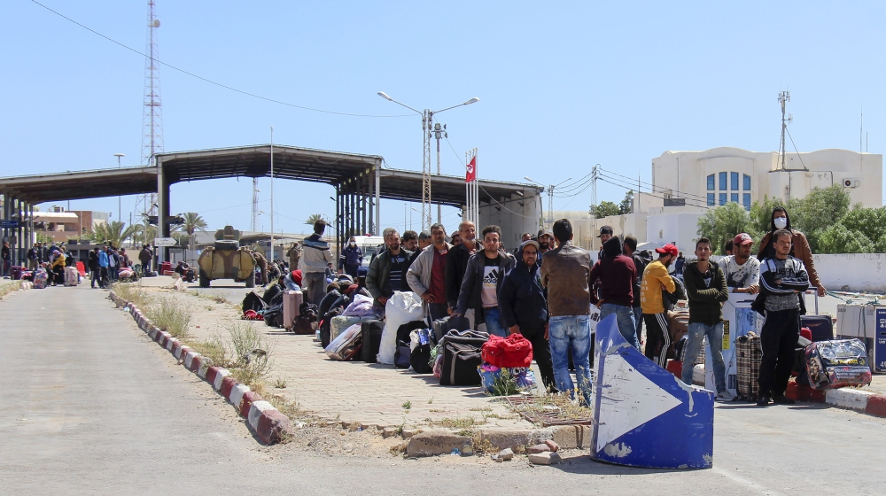 Tunisian workers stranded in Libya wait at the Ras Jedir border post to return to their country, on April 21, 2020. Hundreds of Tunisians stranded for weeks in war-racked Libya due to the coronavirus 