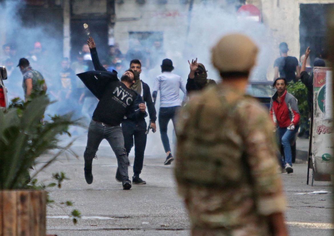 Lebanese protesters hurl rocks at soldiers in the northern port city of Tripoli on April 28, 2020, as anger over a spiralling economic crisis re-energised a months-old anti-government movement in defi