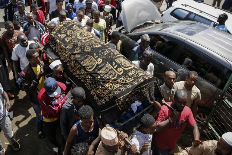 Relatives carry the body of 13-year-old Yasin Hussein Moyo for burial, at the Kariakor cemetery in Nairobi, Kenya Tuesday, March 31, 2020. The family of a 13-year-old boy is in mourning after police i