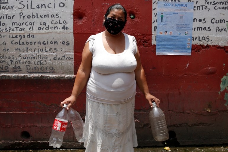 Venezuela /woman waits for her turn to fills plastic bottle