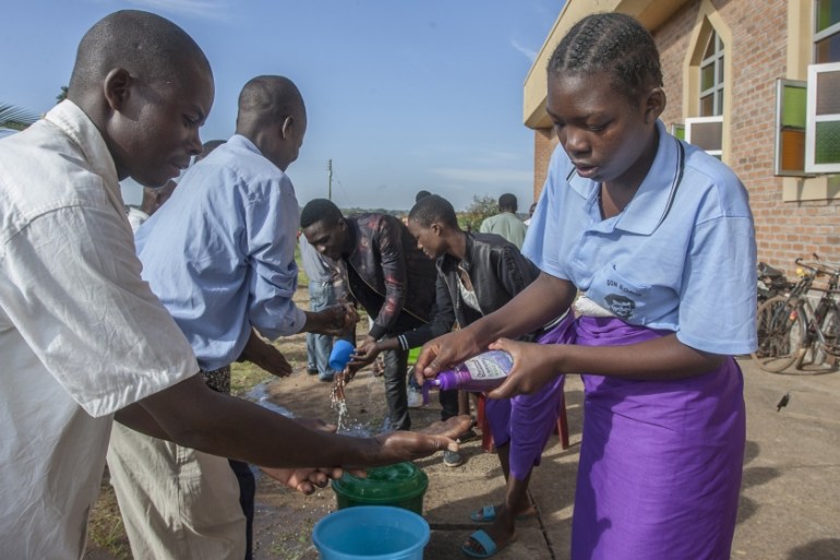 Parishoners wash hands as a preventive measure against the spred of the COVID-19 coronavirus on the last day of full gatherings as a parish at the Saint Don Bosco Catholic Parish in Lilongwe on March