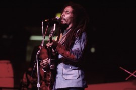 Jamaican Reggae musician Bob Marley (1945 - 1981) plays guitar as he leads his band the Wailers during a performance in the ''Uprising'' tour at Madison Square Garden , New York, New York, September 19,