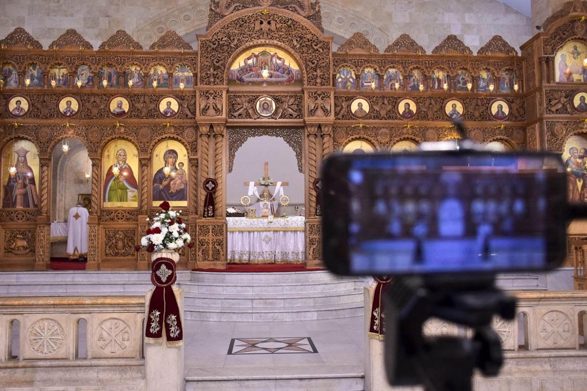 A smartphone broadcasts Easter Sunday mass, during a nationwide lockdown to stem the spread of the novel coronavirus, at the Prophet Elias Greek Orthodox Church in Syria''s northern city of Aleppo on A