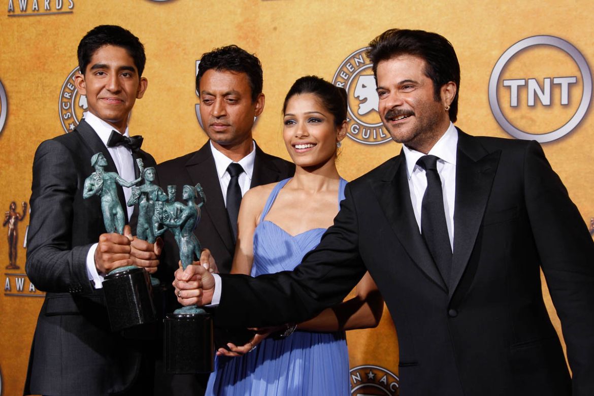 Members of the cast of "Slumdog Millionaire" pose backstage with the award for outstanding performance by a cast in a motion picture during the 15th Annual Screen Actors Guild Awards on Sunday, Jan. 2