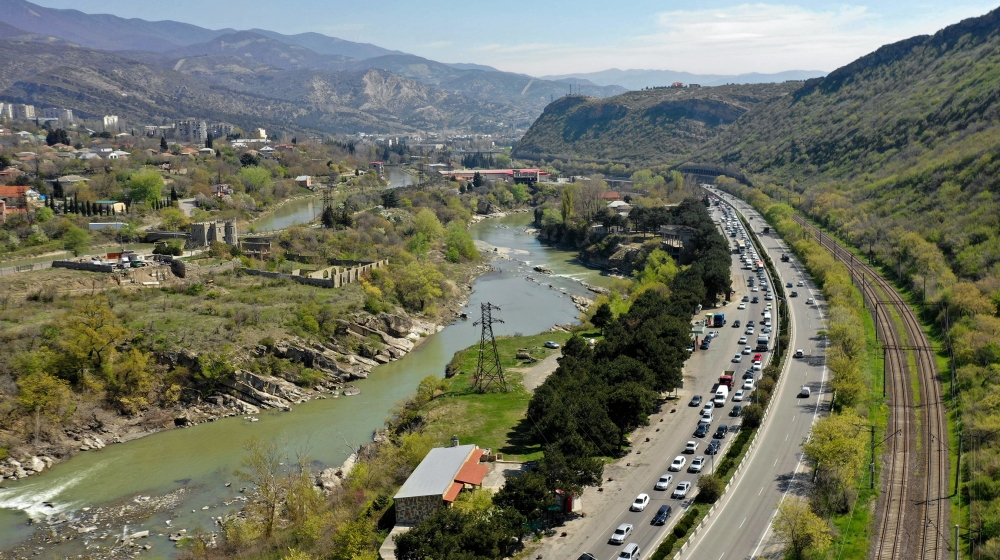 An aerial view shows a car flow leaving Tbilisi on April 15, 2020. The country will ban entry to and exit from Tbilisi and three more major cities for 10 day from tonight in a bid to stop the spread o