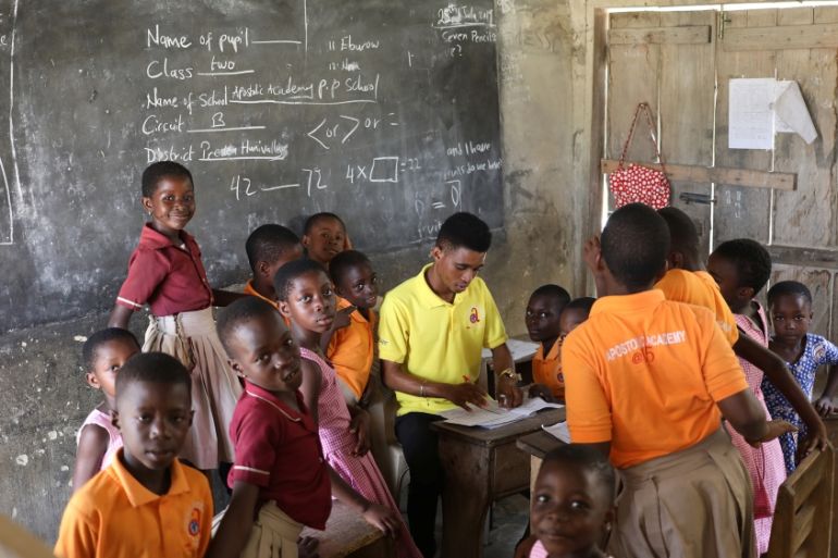 School children gather around their teacher in class in Prestea, a mining town in southwest Ghana, July 25, 2019. REUTERS/Siphiwe Sibeko