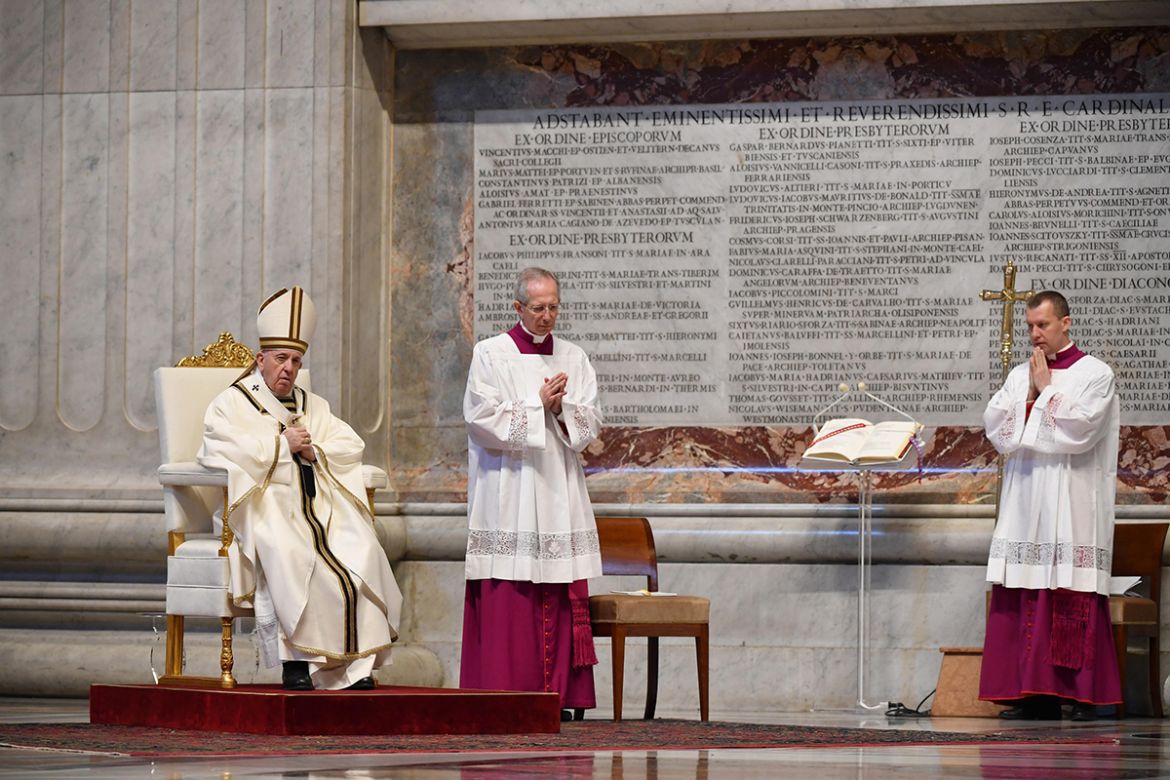 epa08358478 Pope Francis (L) looks on as he celebrates Easter Sunday Mass behind closed doors at St. Peter''s Basilica in The Vatican, 12 April 2020. The mass is held behind closed doors during the loc