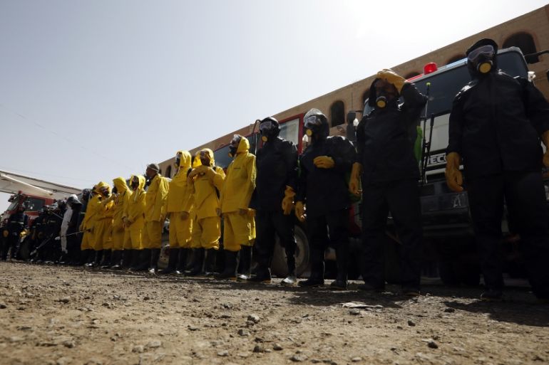 Staff of the Yemeni civil defense wearing protective gear, prepare to spray disinfectant during a demonstration of an anti-proliferation training of the SARS-CoV-2 coronavirus, in Sanaa, Yemen, 12 Apr