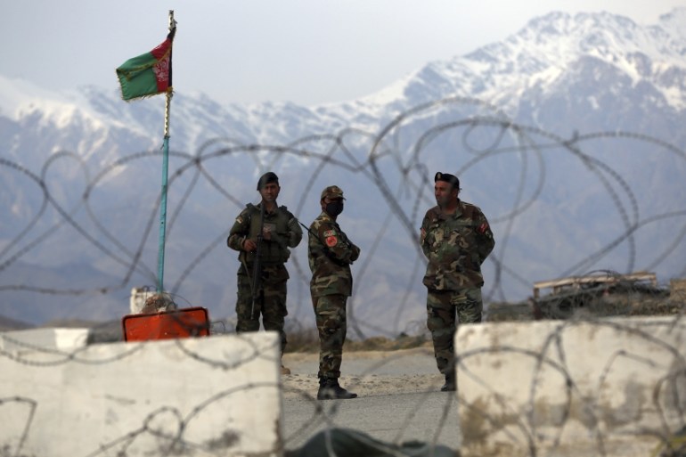 Afghan National Army soldiers stand guard at a checkpoint near the Bagram base in northern Kabul, Afghanistan, Wednesday, April 8, 2020. An Afghan official said Wednesday that the country has released