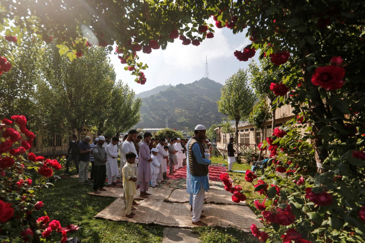 Kashmiri Muslims pray in the garden of a house while celebrating Eid al-Fitr, the Muslim festival marking the end of the holy fasting month of Ramadan, amid the spread of the coronavirus disease (COVI