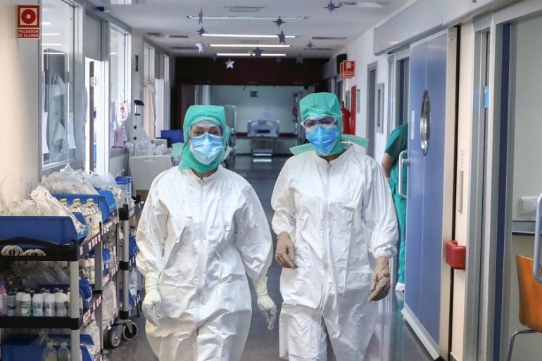 Medical workers wearing personal protective equipment (PPE) walk at the intensive care unit (ICU) of the La Paz hospital amid the coronavirus disease (COVID-19) outbreak in Madrid, Spain April 28, 202