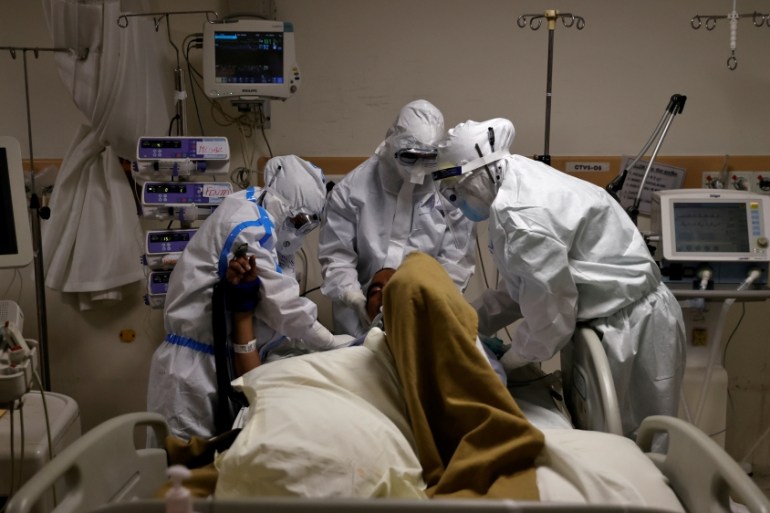 Medical workers treat patients infected with the coronavirus disease in New Delhi