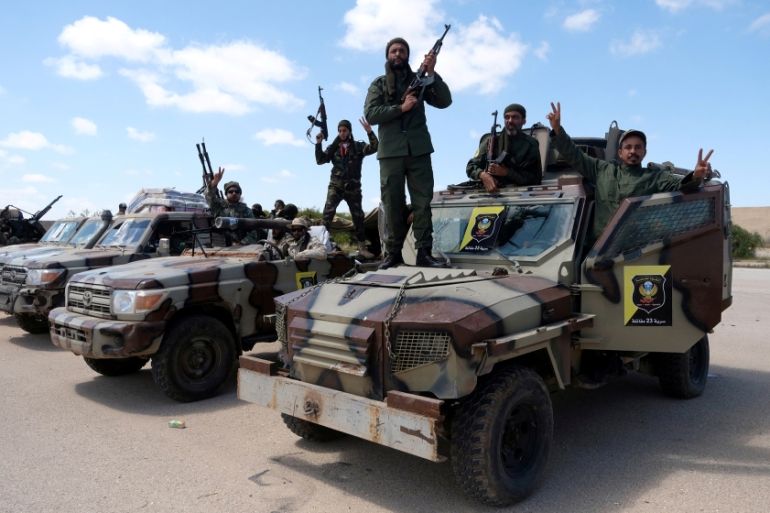 Libyan National Army (LNA) members, commanded by Khalifa Haftar, pose for a picture as they head out of Benghazi to reinforce the troops advancing to Tripoli, in Benghazi, Libya April 7, 2019. REUTERS