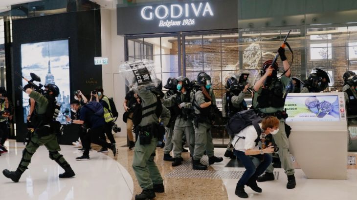 Riot police raise their pepper spray projectile inside a shopping mall as they disperse anti-government protesters during a rally, in Hong Kong, China May 10, 2020. REUTERS/Tyrone Siu