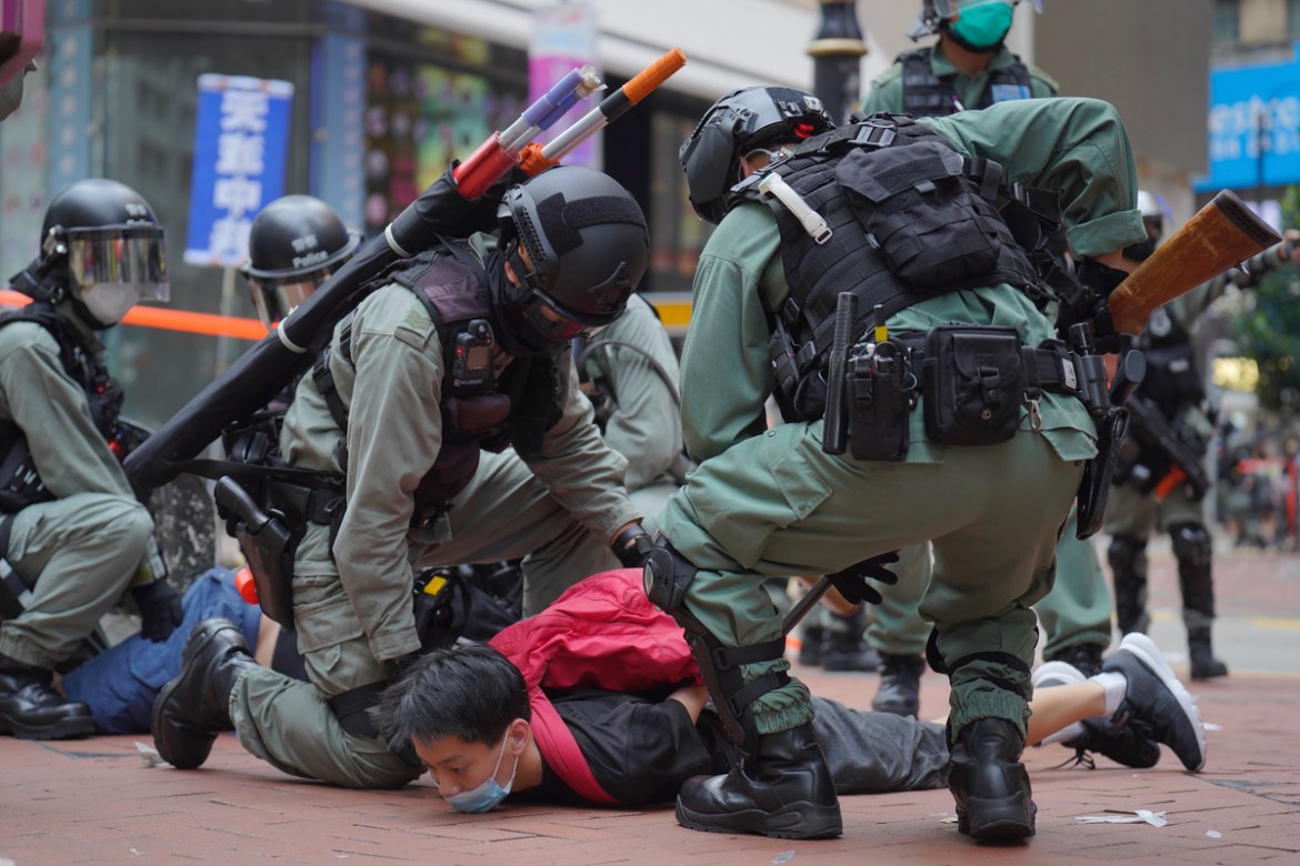Riot police detain a protester during a demonstration against Beijing''s national security legislation in Causeway Bay in Hong Kong, Sunday, May 24, 2020. Hong Kong police fired volleys of tear gas in