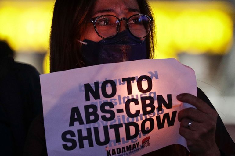 A protester holds a slogan during a rally in metropolitan Manila, Philippines on Monday, Feb. 10, 2020. The Philippine government’s chief lawyer asked the Supreme Court on Monday to shut down the coun