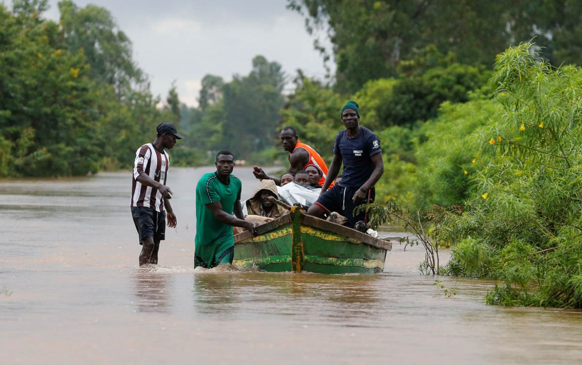 Residents use a boat to evacuate with their animals from the flood waters after River Nzoia burst its banks and due to the backflow from Lake Victoria, in Buyuku village of Budalangi, in Busia County,