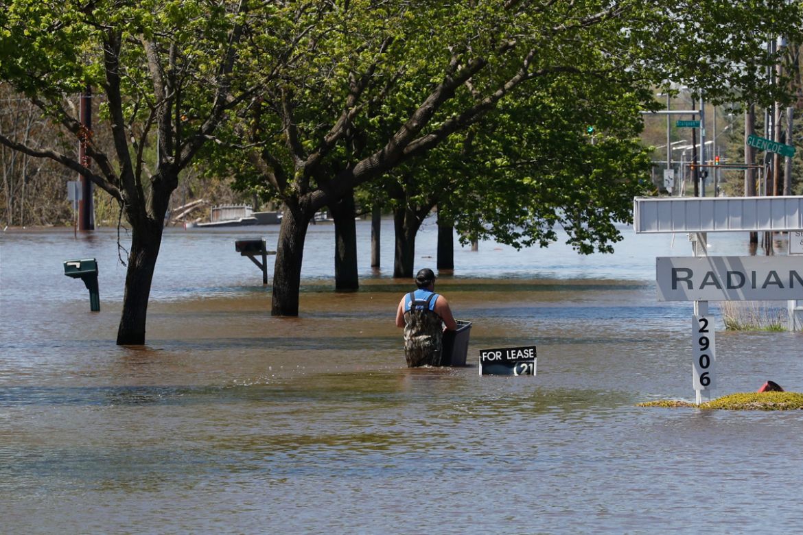 CORRECTS CITY TO MIDLAND, INSTEAD OF FREELAND Waters overflow the Tittabawassee River, Wednesday, May 20, 2020, in Midland, Mich. People living along two mid-Michigan lakes and parts of a river have b