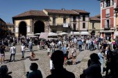 Crowds of people gather to watch an aerobatic demonstration by the Italian Air Force, in the town of Codogno as Italy starts to ease its coronavirus lockdown, May 25 [Marzio Toniolo/Reuters]