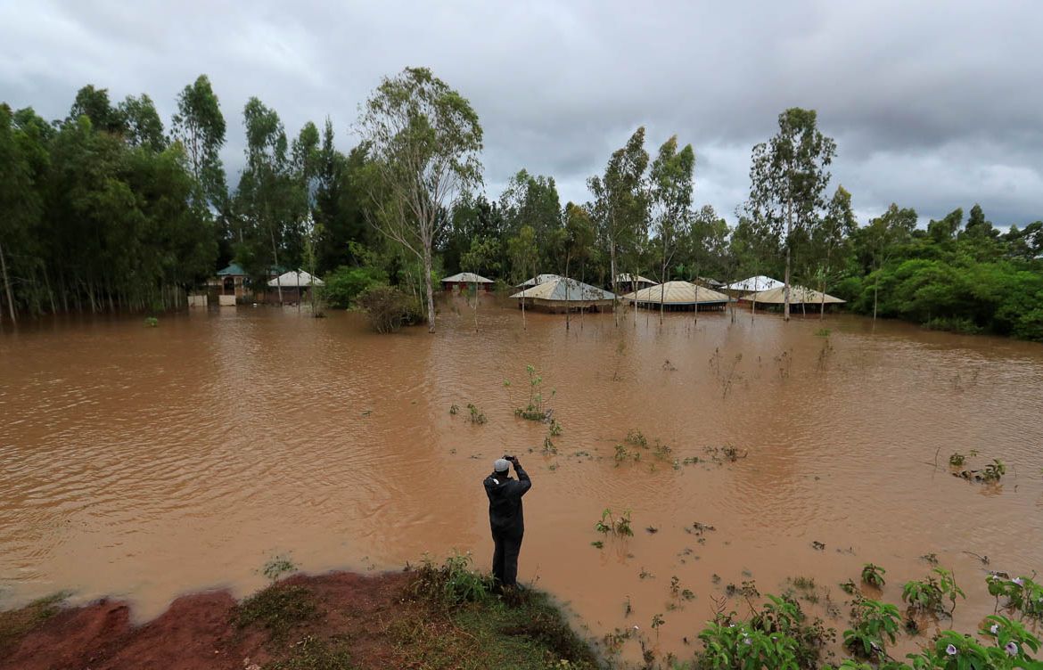 A man takes a photograph of a flooded village after River Nzoia burst its banks and due to the backflow from Lake Victoria, in Nyadorera, Siaya County, Kenya May 2, 2020. REUTERS/Thomas Mukoya