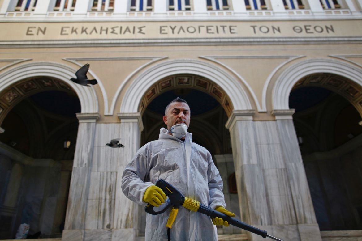 epa08392759 (06/13) Municipal workers Panagiotis Mpakoulas, 55, wearing a protective suit poses for a picture as he sprays disinfectant during the lockdown of the coronavirus disease (COVID-19) outbre