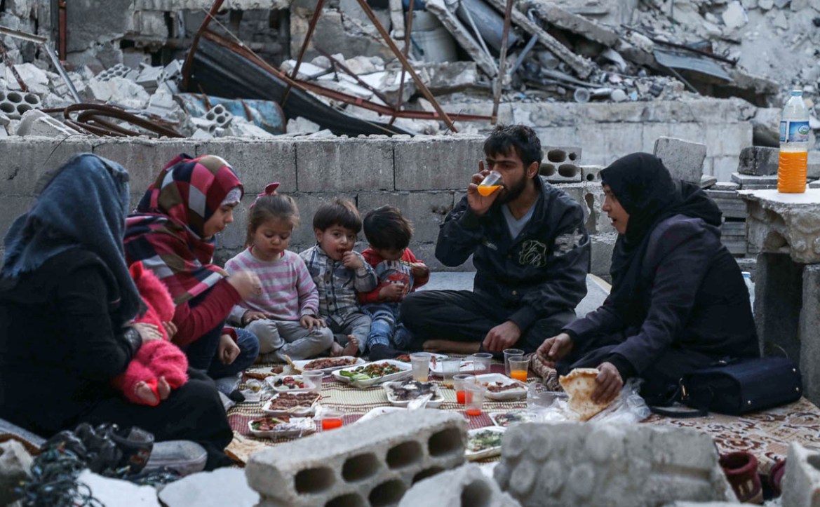 This picture taken on May 4, 2020 during the Muslim holy fasting month of Ramadan shows members of the displaced Syrian family of Tareq Abu Ziad, from the town of Ariha in the southern countryside of