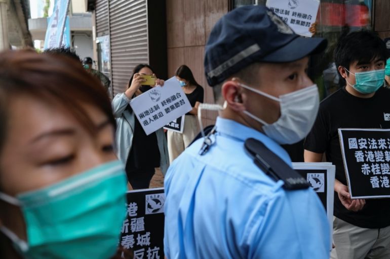 Activists march against new security laws, near China?s Liaison Office, in Hong Kong