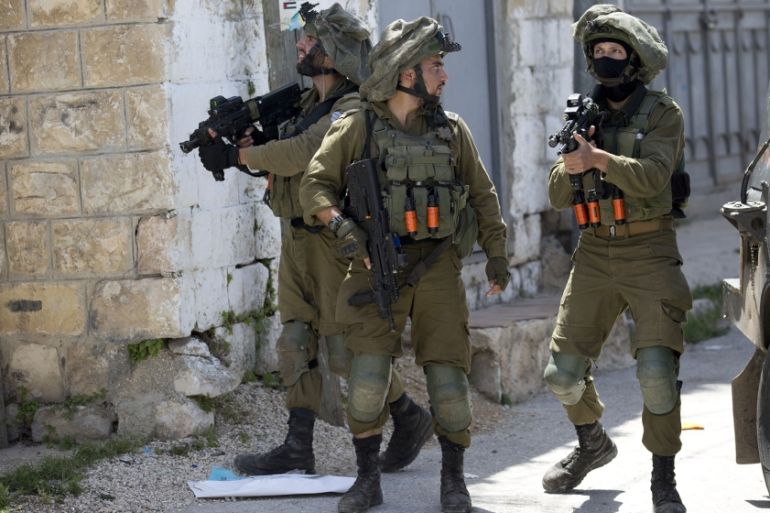 Israeli soldiers patrol after a soldier was killed when a rock thrown off a rooftop struck him in the head g during an arrest raid, in the village of Yabad near the West Bank city of Jenin, Tuesday, M