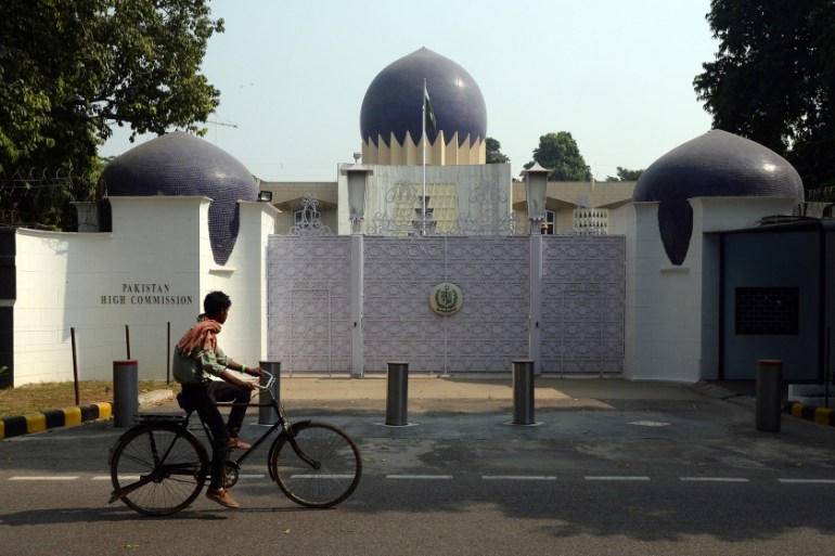 An Indian cyclist rides past the entrance to the Pakistan High Commission in New Delhi on October 27, 2016. India will expel a Pakistani visa official for "espionage activities", the foreign ministry