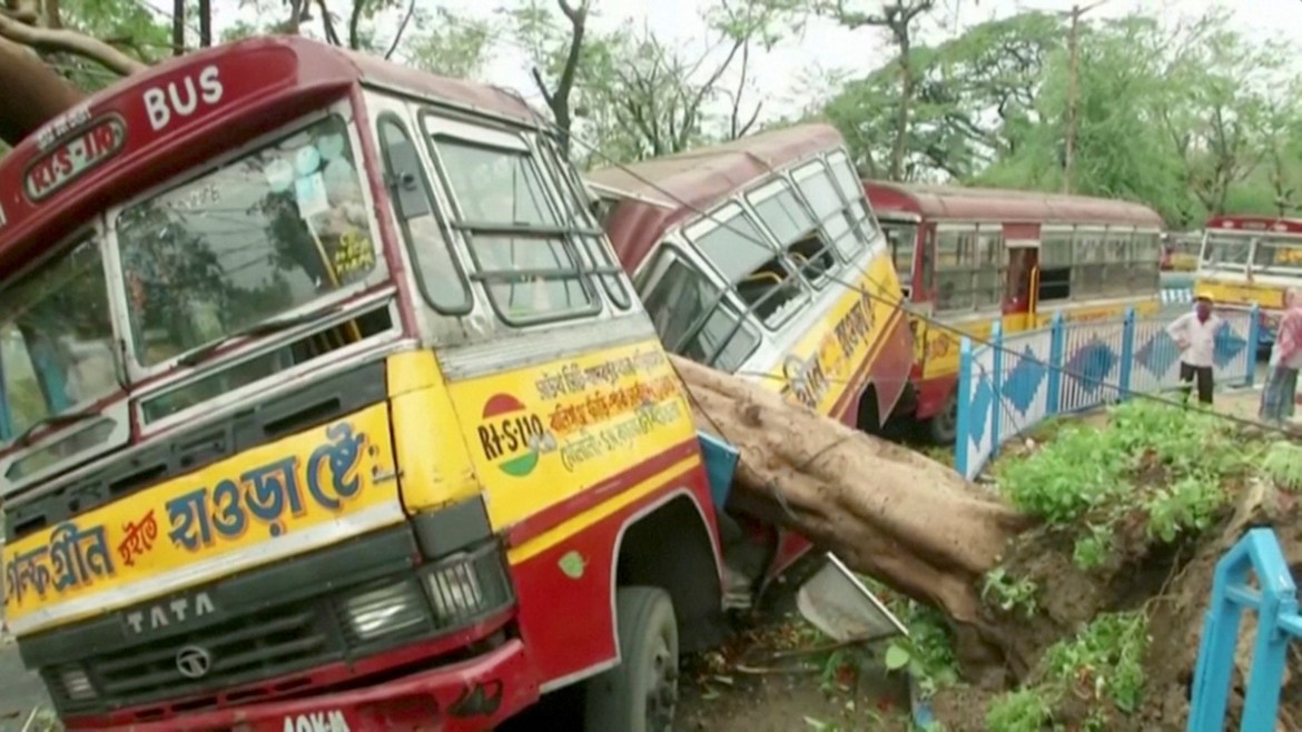 A bus damaged by a fallen tree due to Cyclone Amphan, is seen in Kolkata, West Bengal, India, May 21, 2020, in this still image from video. ANI via REUTERS TV ATTENTION EDITORS - THIS IMAGE HAS BEEN
