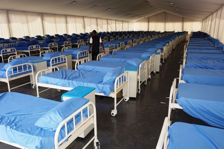 A manwalks between rows of beds inside the male section at a COVID-19 coronavirus isolation centre at the Sani Abacha stadium in Kano, Nigeria, on April 7, 2020. The centre is being built with donatio