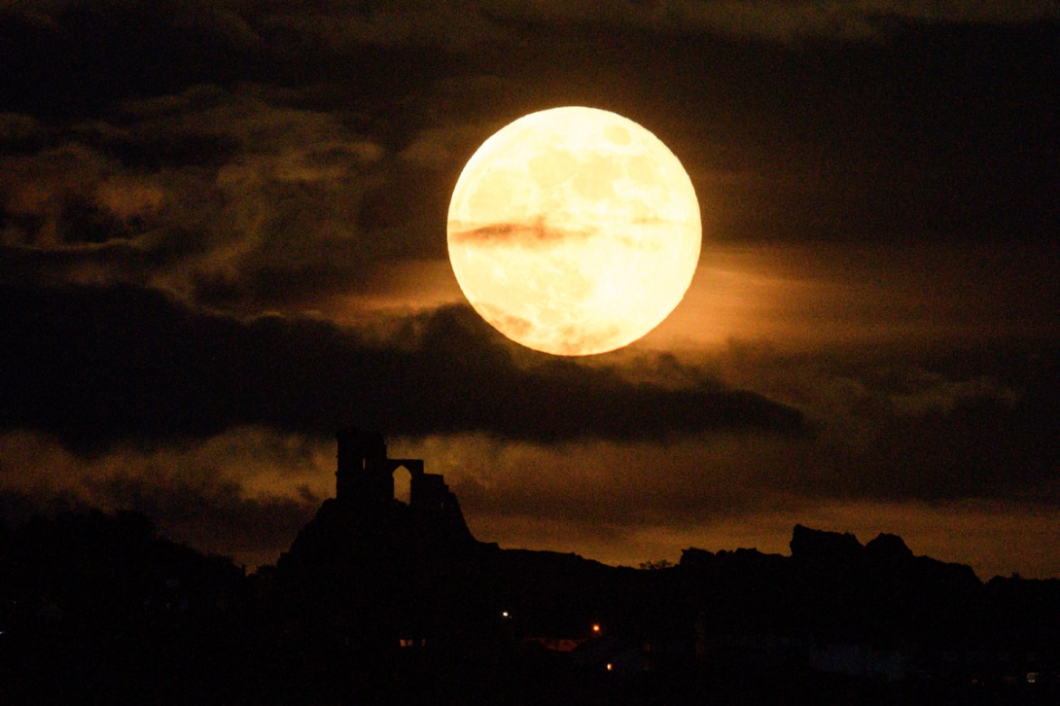 A supermoon rises over Mow Cop Castle near Stoke-on-Trent, central England on May 7, 2020. OLI SCARFF / AFP