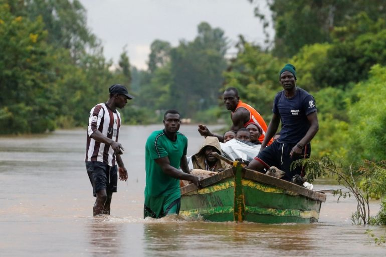 Residents use a boat to evacuate with their animals from the flood waters after River Nzoia burst its banks and due to the backflow from Lake Victoria, in Buyuku village of Budalangi, in Busia County