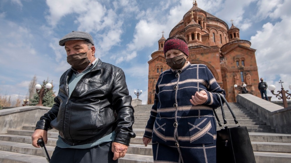 Armenian Apostolic Church believers wearing protective masks leave the Cathedral in Abovyan, some 30km from Yerevan on Easter Sunday on April 12, 2020, amid the COVID-19 o