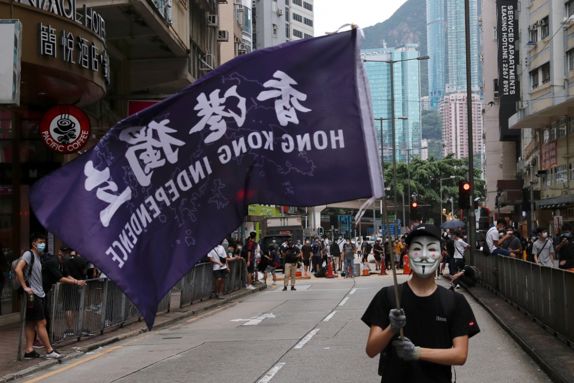 A masked anti-government protester holds a flag supporting Hong Kong independence during a march against Beijing''s plans to impose national security legislation in Hong Kong, China May 24, 2020. REUTE