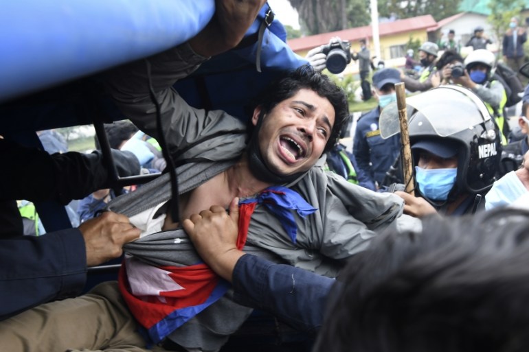 A demonstrator shouts slogans after he was detained by the police during a protest against India''s newly inaugurated link road to the Chinese border, in Kathmandu on May 11, 2020. Nepal protested Ind