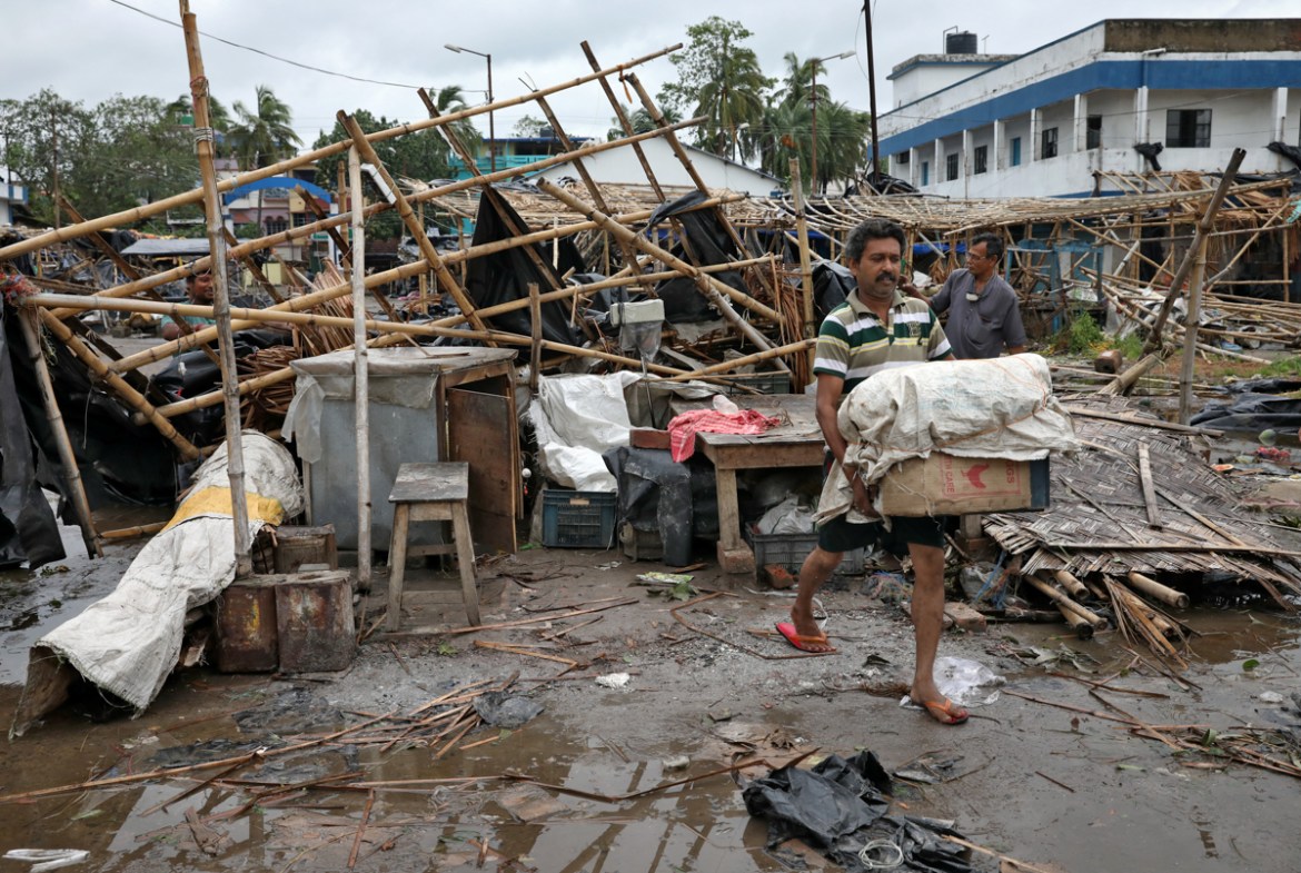 A man salvages his belongings from the rubble of a damaged shop after Cyclone Amphan made its landfall, in South 24 Parganas district in the eastern state of West Bengal, India, May 21, 2020. REUTERS/