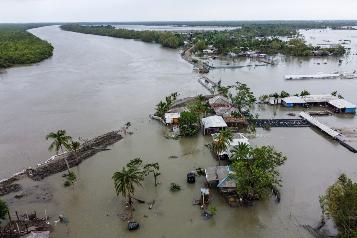 An aerial view shows flooded houses and buildings as a dam broke after the landfall of cyclone Amphan in Shyamnagar on May 21, 2020. - At least 22 people died as the fiercest cyclone to hit parts of B