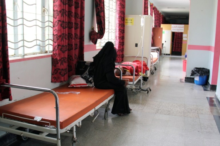 A woman sits on a bed at the emergency ward of a hospital, amid fear of the spread of the coronavirus disease (COVID-19), in the city of Taiz