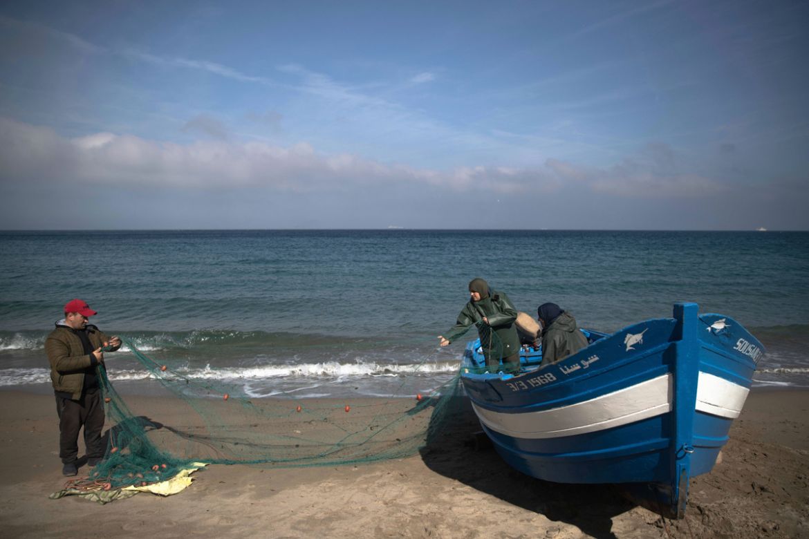 In this Tuesday, Feb. 11, 2020 photo, members of the first Moroccan female fishing cooperative prepare fishing nets to go to sea, in the village of Belyounech on the coast of the Mediterranean, northe