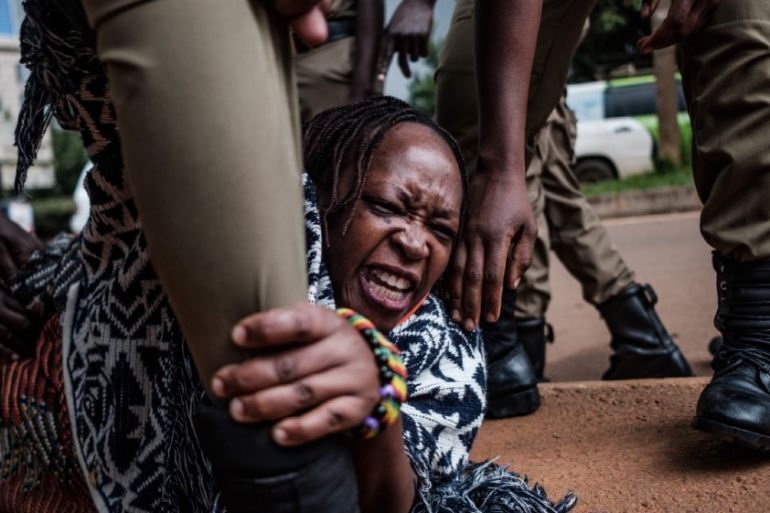 Stella Nyanzi (C), a prominent Ugandan activist and government critic, is arrested by police officers as she organised a protest for more food distribution by the government to people